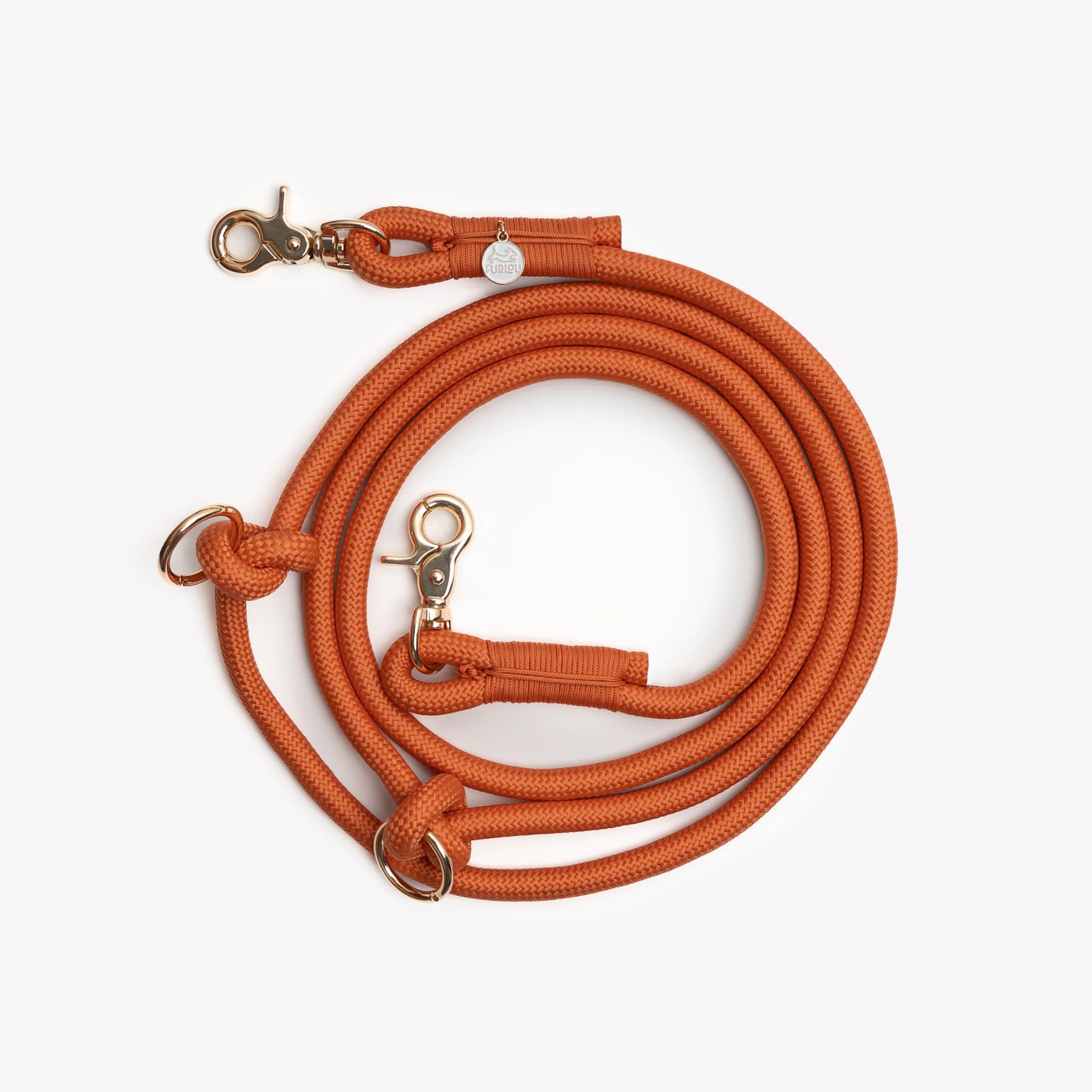 The Terracotta hands-free braided leash by Furlou shown coiled, highlighting the durable braided texture and secure gold-toned clasps.