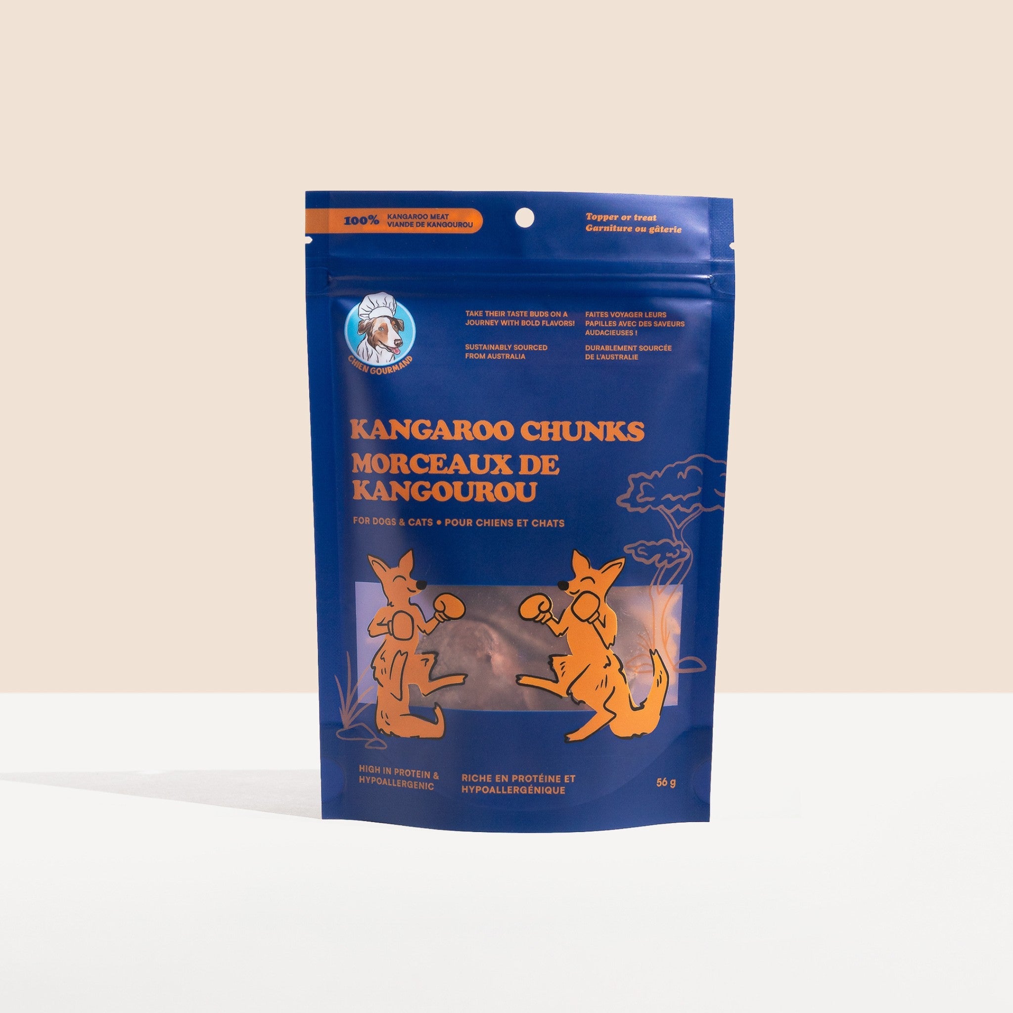 A front-facing studio shot of a 56g blue stand-up pouch of Chien Gourmand Kangaroo Chunks, featuring illustrations of boxing kangaroos and bilingual English/French product labeling.