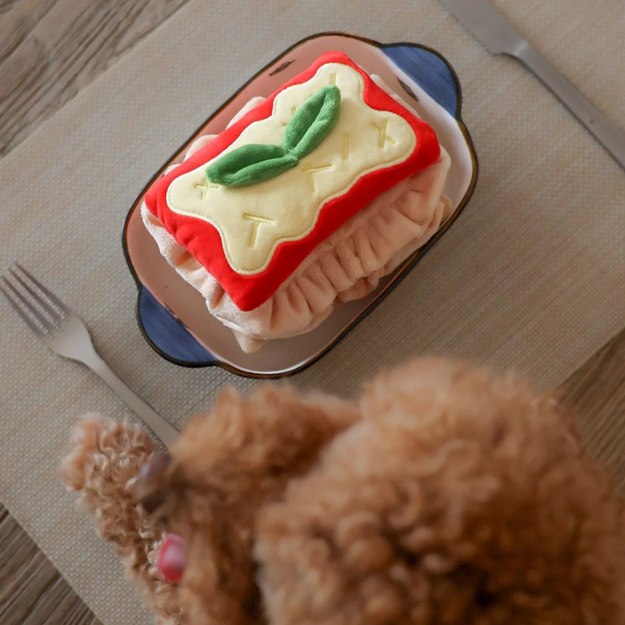 Top view of the lasagna interactive dog puzzle toy showcasing the soft plush layers and ruffled pasta edges.