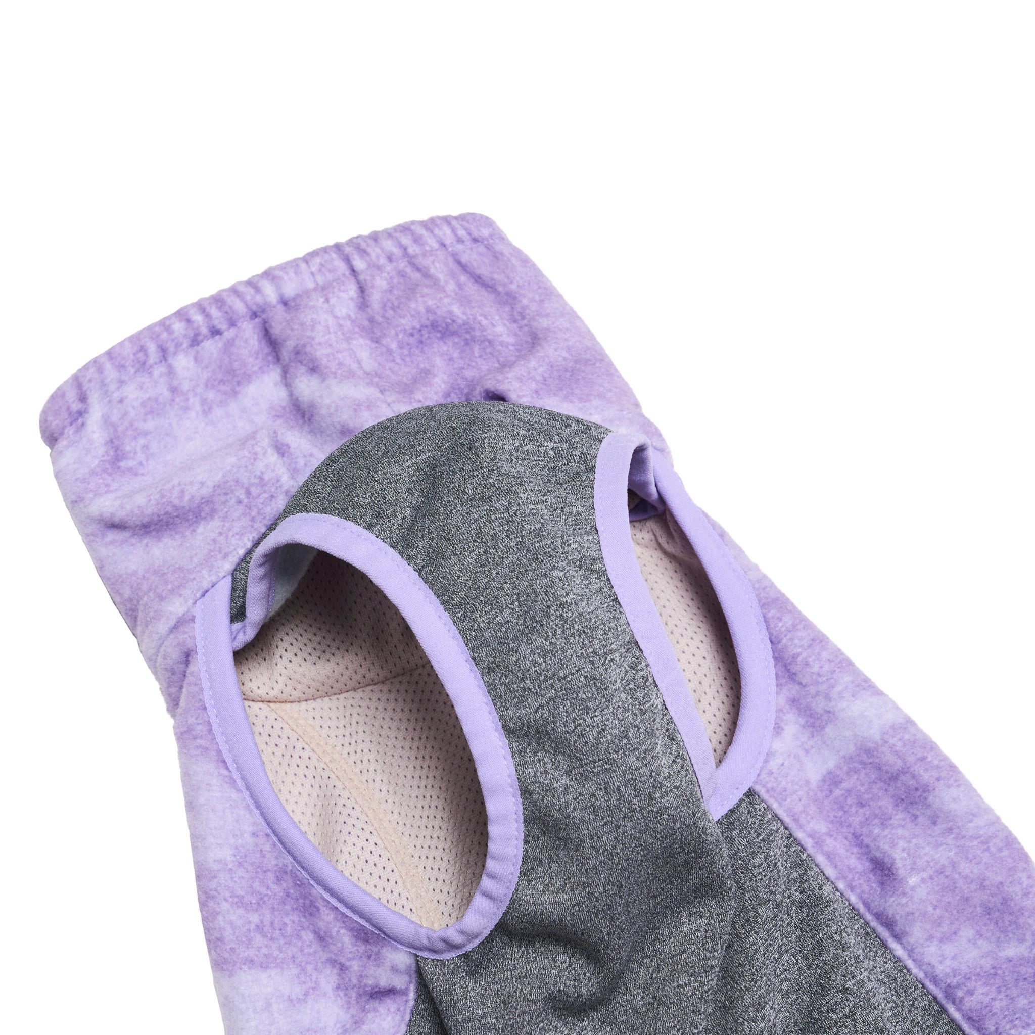 An interior close-up shot of the Merlot Shelter dog jacket in purple, showing the flexible grey stretch underbelly fabric and comfortable stretch leg hole openings with soft purple piping.