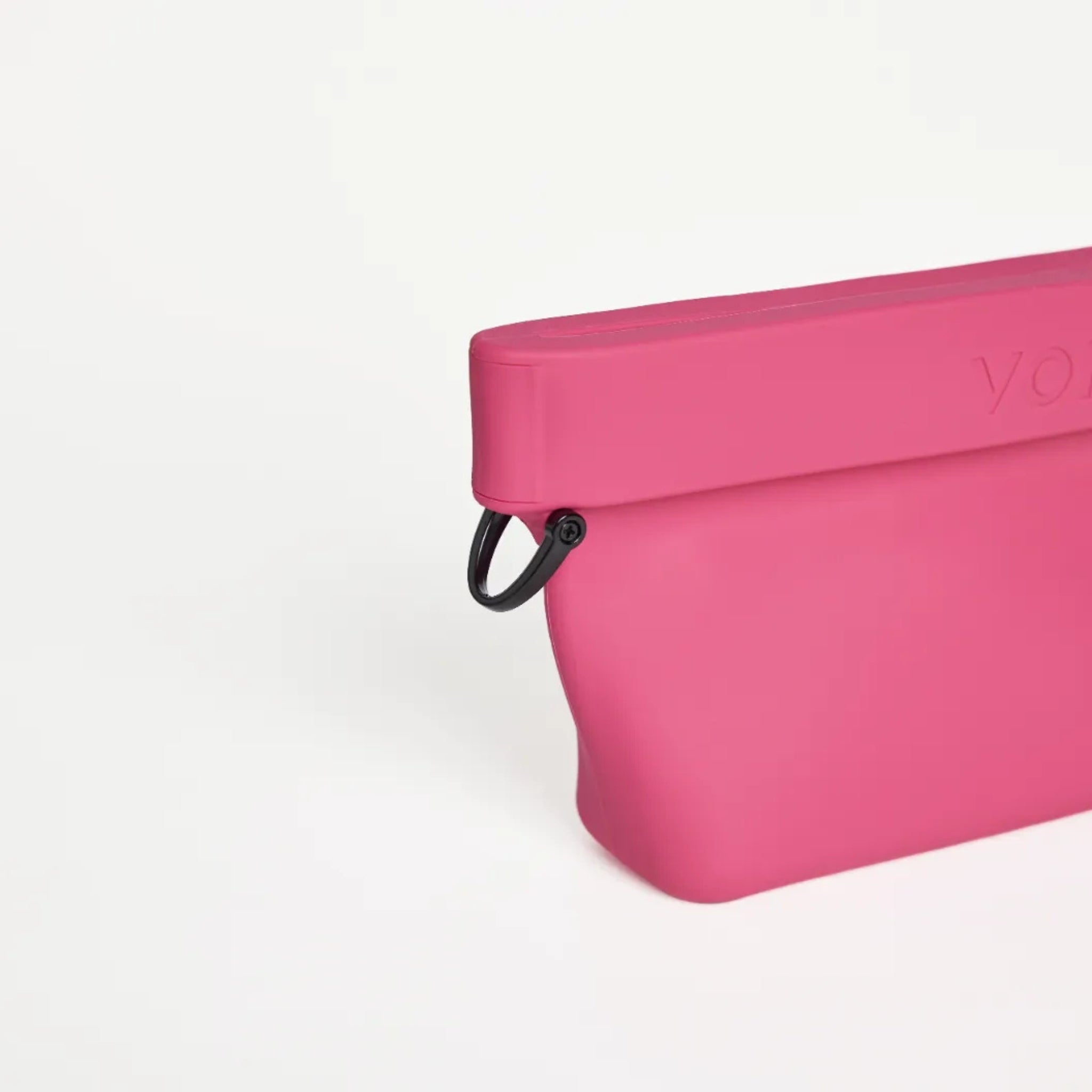 Close-up view of the black metal D-ring attachment on the side of the fuchsia pink silicone Ultimate Treat Pouch The Mini by Voilapets.