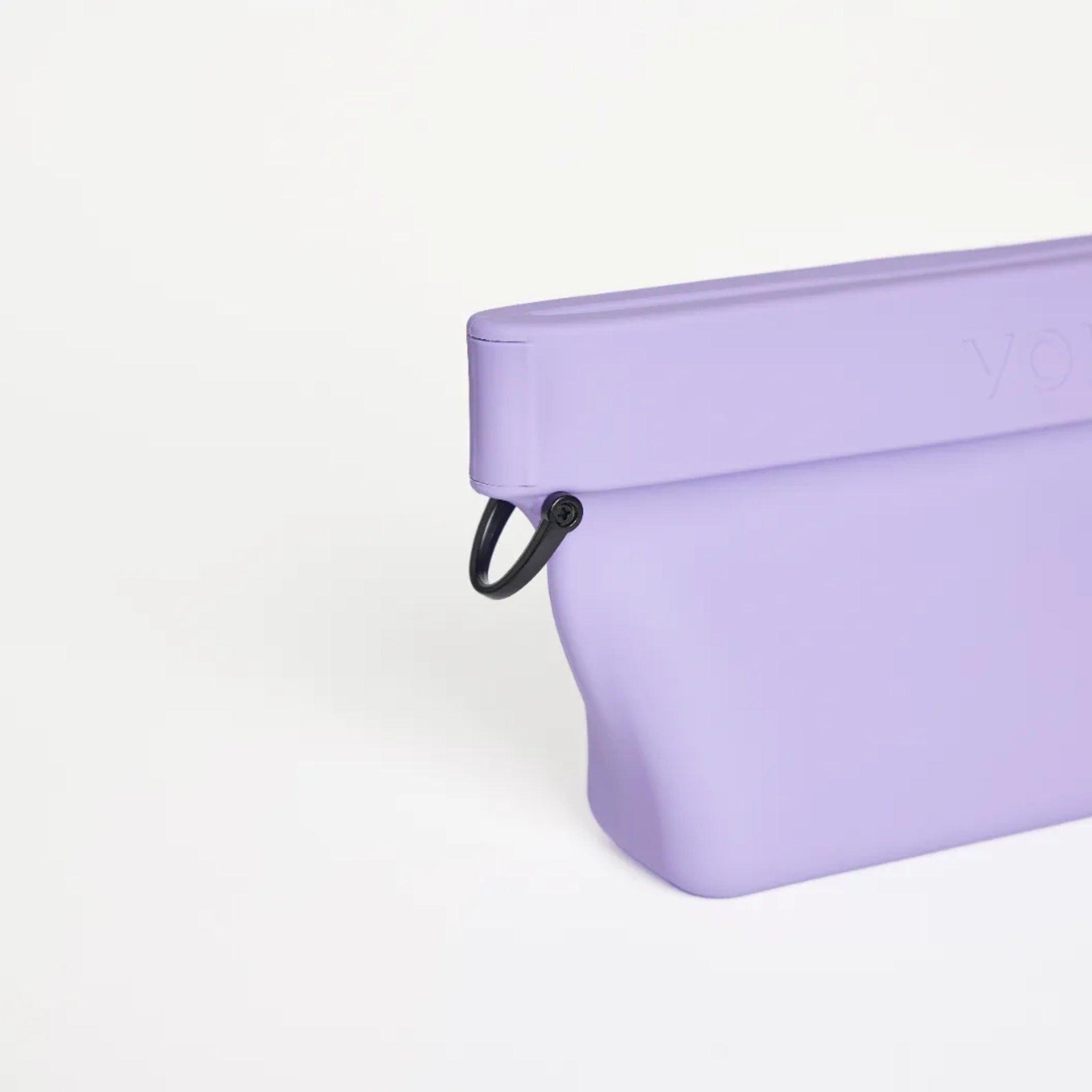 Close-up view of the black metal D-ring attachment on the side of the lilac purple silicone Ultimate Treat Pouch The Mini by Voilapets.