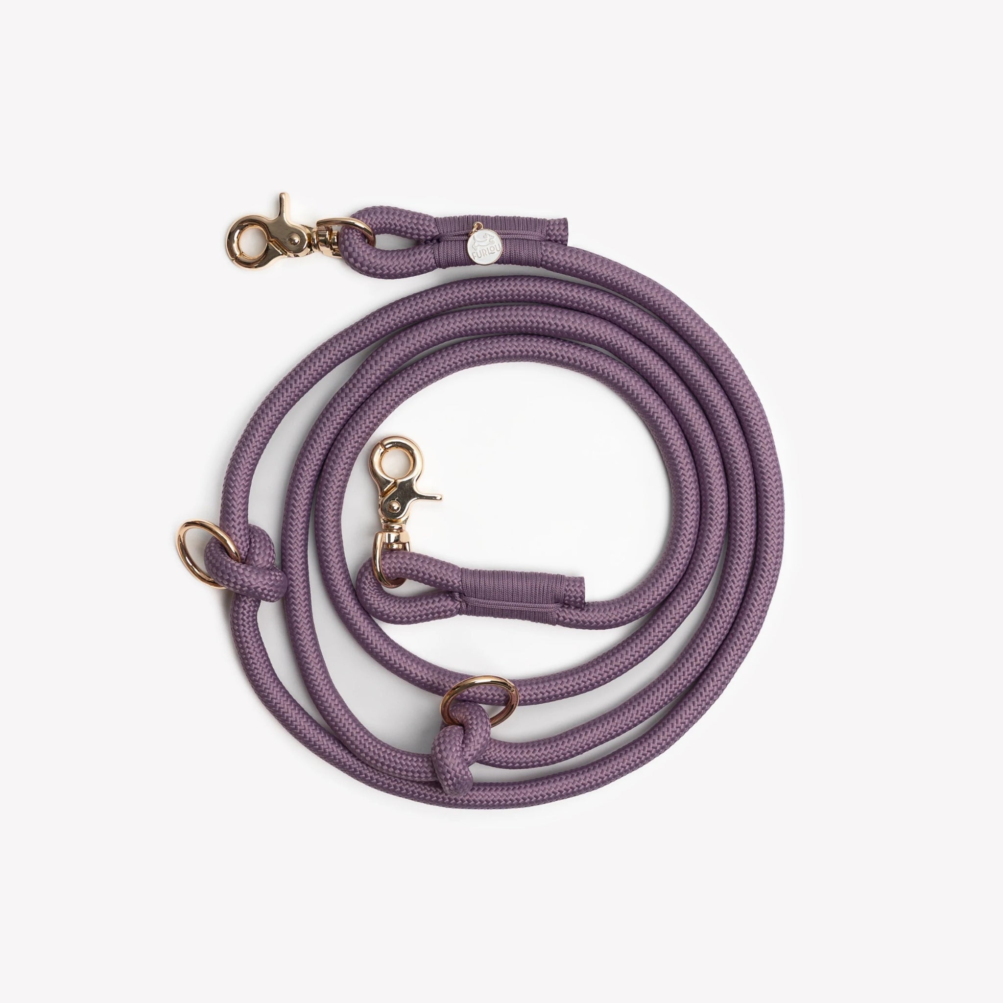 The lilac hands-free braided leash by Furlou displayed in a neat coil, emphasizing the braided purple cord and secure hardware clasps.