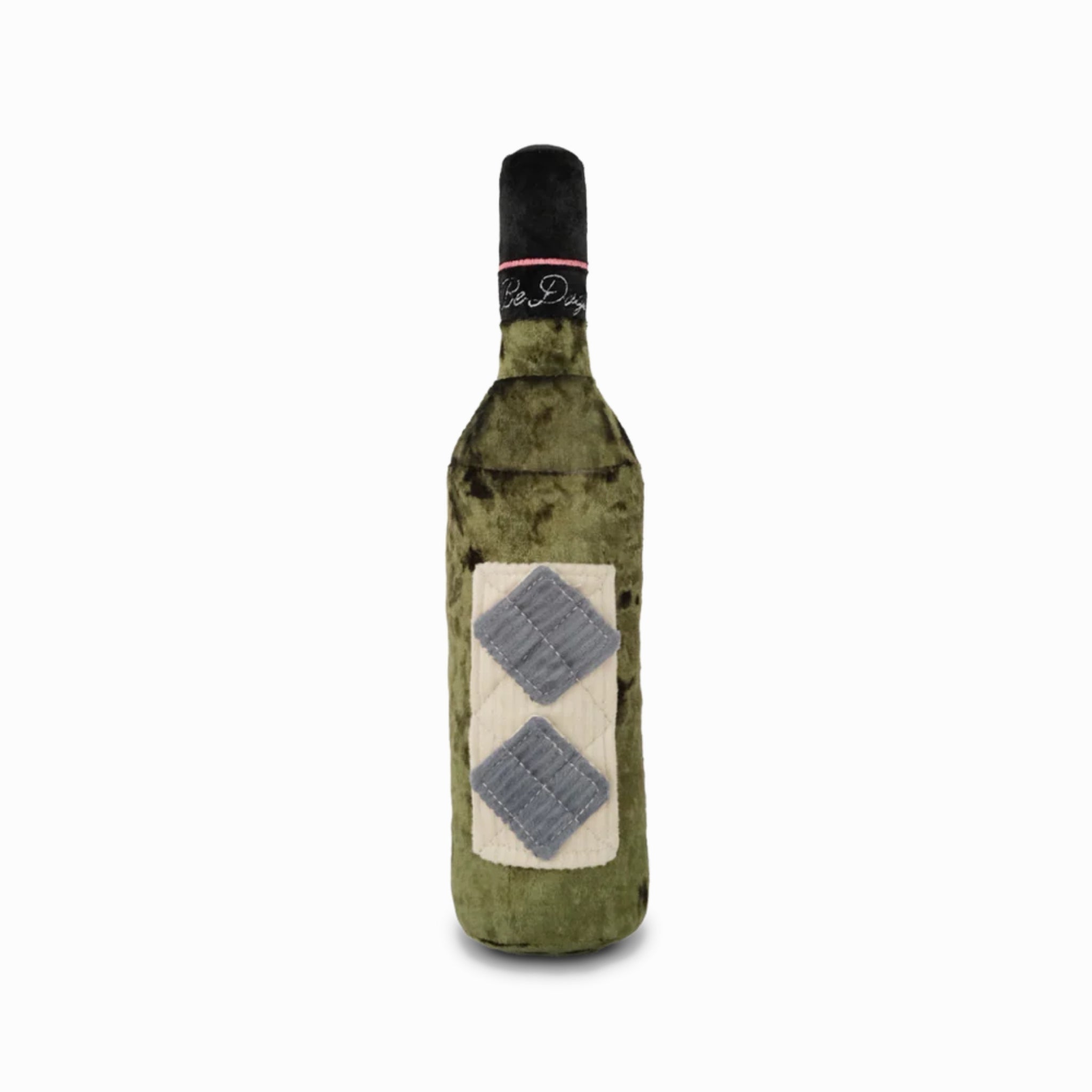 A studio product shot on a plain white background showcasing the olive green velvet Merlot wine bottle interactive dog toy with its quilted label and grey corduroy treat-hiding pockets.