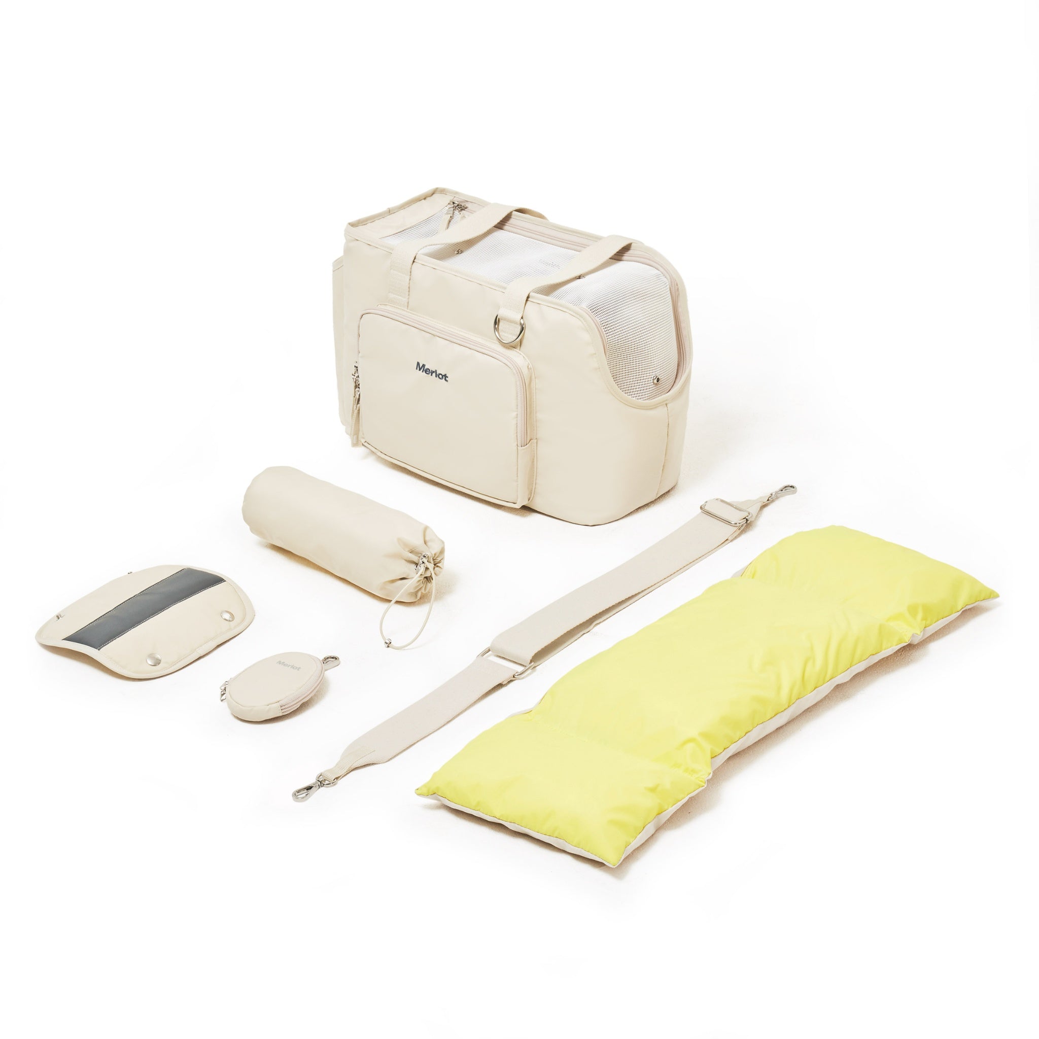 An overhead studio flat lay showcasing the full lemon cream Merlot Mermer dog carrier set, featuring the main travel tote bag, a reversible yellow cushion, a cross-body strap, a shoulder pad, and matching storage pouches.