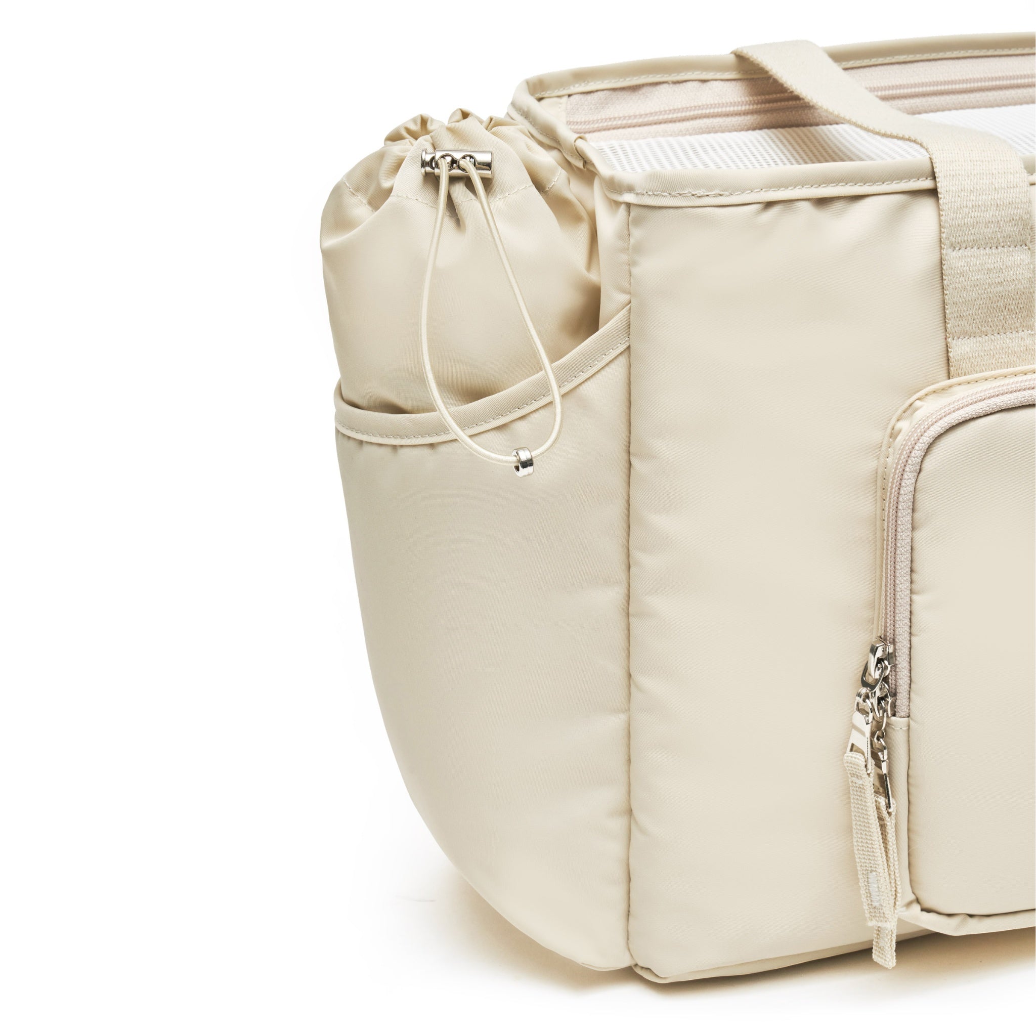 A close-up studio detail shot of the side panel on the lemon cream Merlot Mermer dog carrier bag, highlighting the premium stitching, toggle drawstring pocket, and silver zipper hardware.