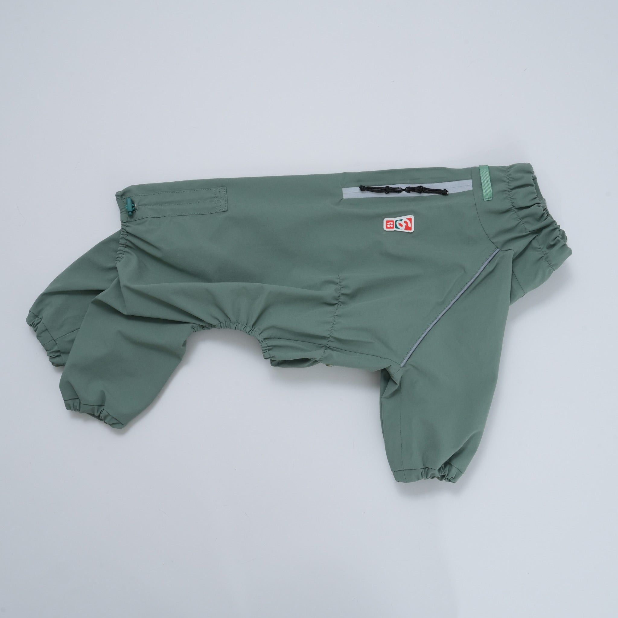 A side flat lay product shot of the full-coverage khaki green Puppy Gallery waterproof dog rain suit, detailing its elasticized leg cuffs and sleek silhouette.