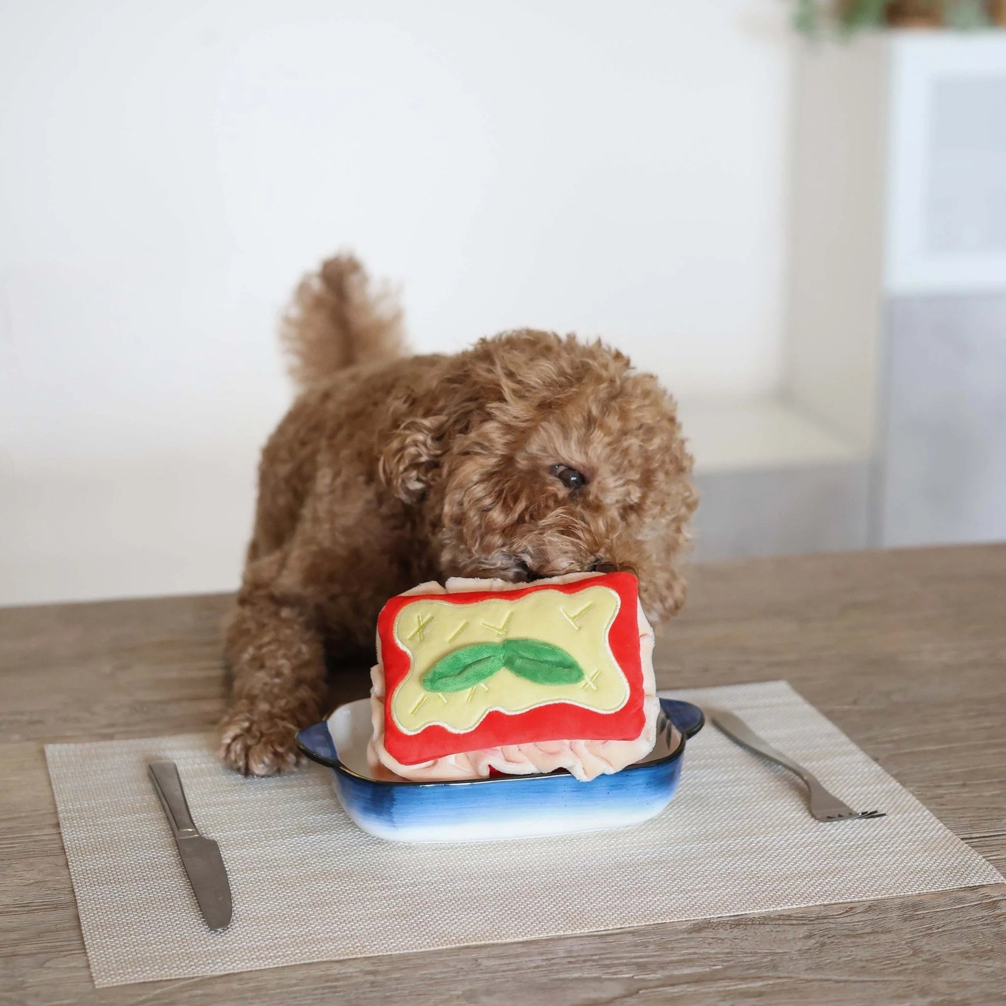 The pups & bubs lasagna nosework dog toy served in a cute dish for an interactive pet brain game.