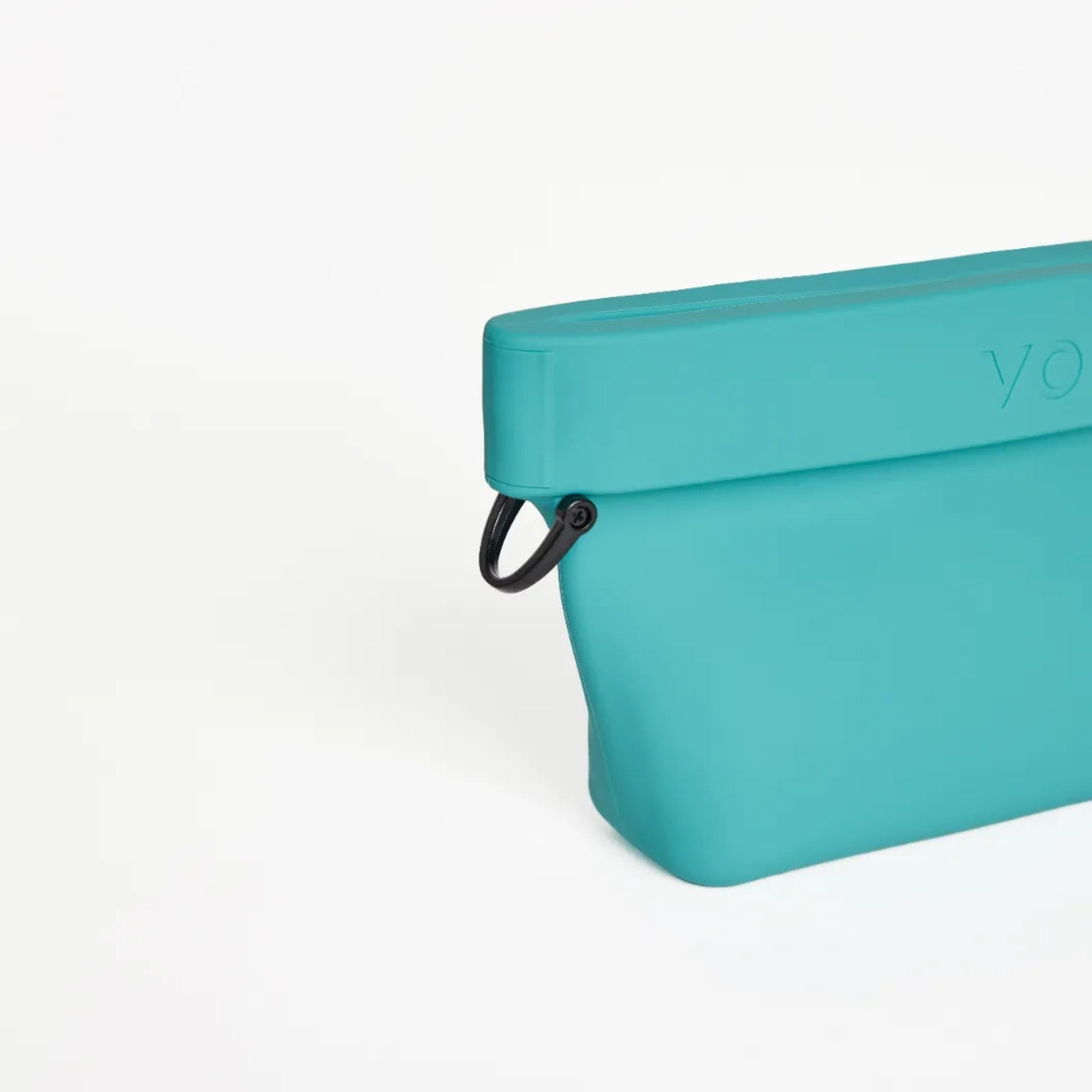 Close-up view of the black metal D-ring attachment clip on the side of the cyan blue silicone Ultimate Treat Pouch The Mini by Voilapets.