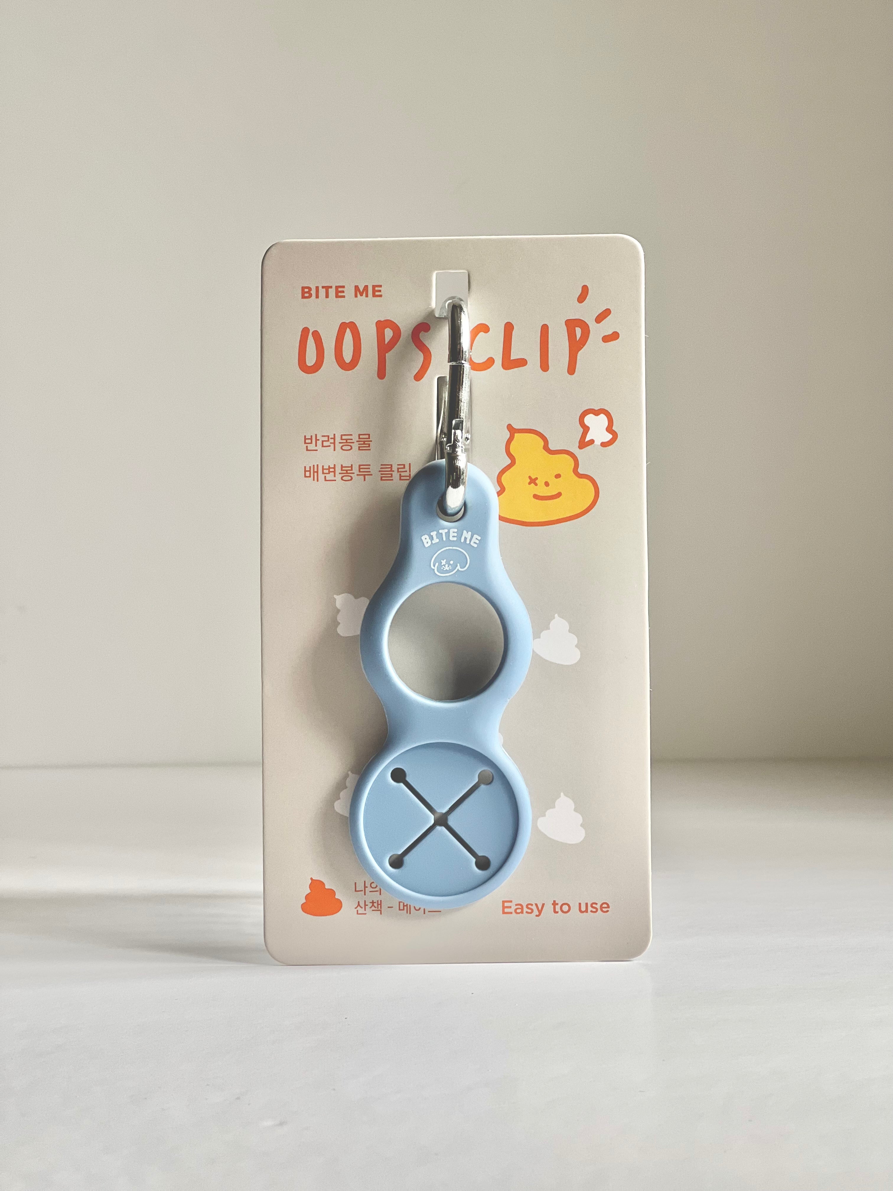 Bite Me Oops Clip Poop Bag Holder in Dusk Blue, featuring a sleek design with a carabiner clip for quick attachment and use.
