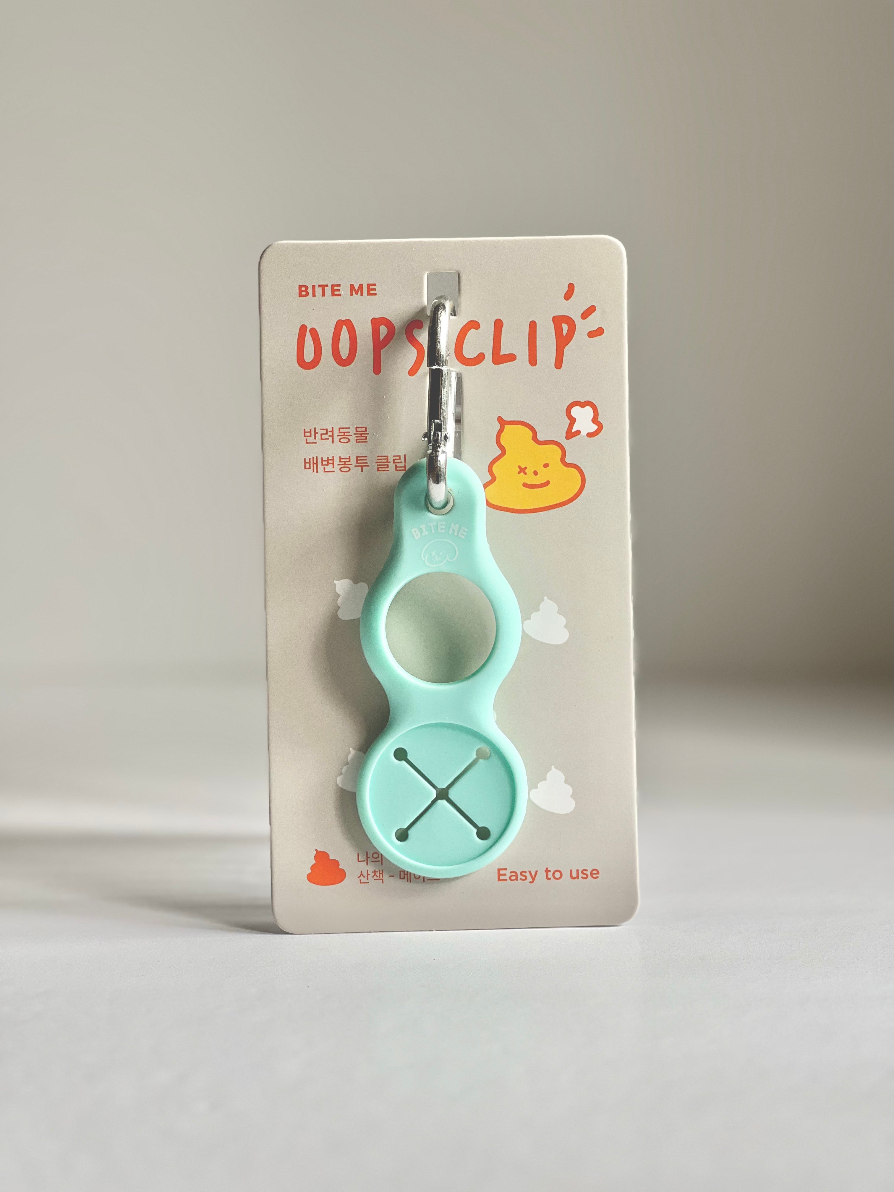 Bite Me Oops Clip Poop Bag Holder in Turquoise, featuring a practical design with a carabiner clip for quick access on walks.