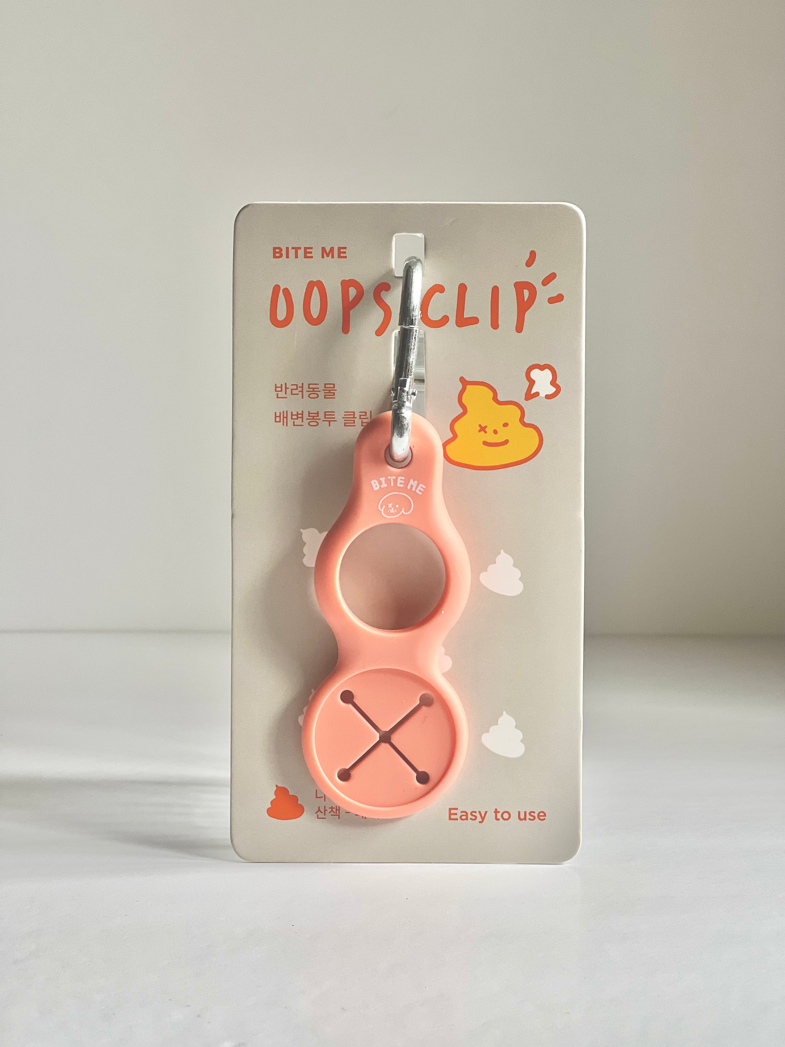 Bite Me Oops Clip Poop Bag Holder in Peach, with a fun, colorful design and a carabiner clip for effortless portability.